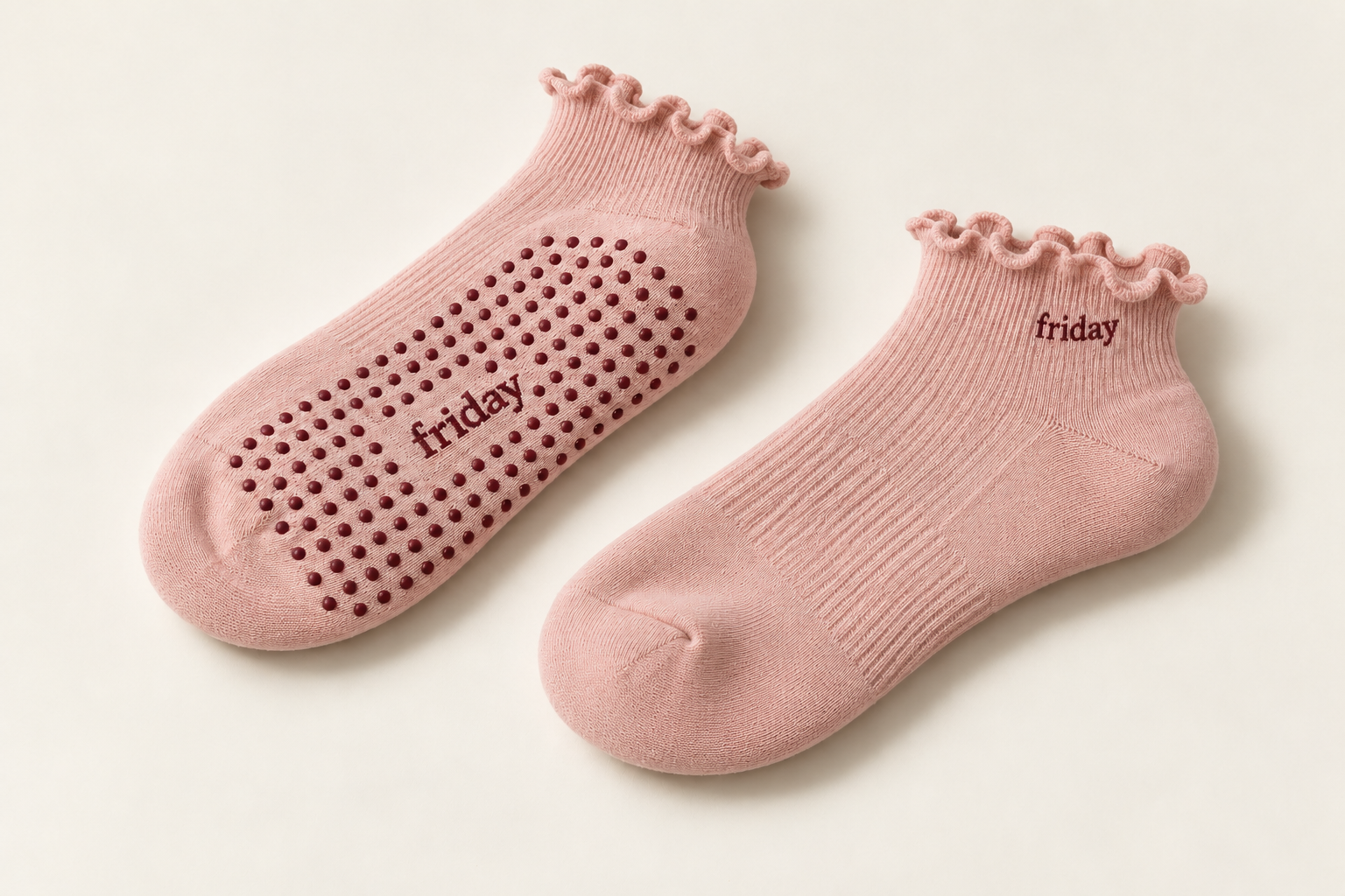 Soft blush Friday Pilates socks showing the grip underneath